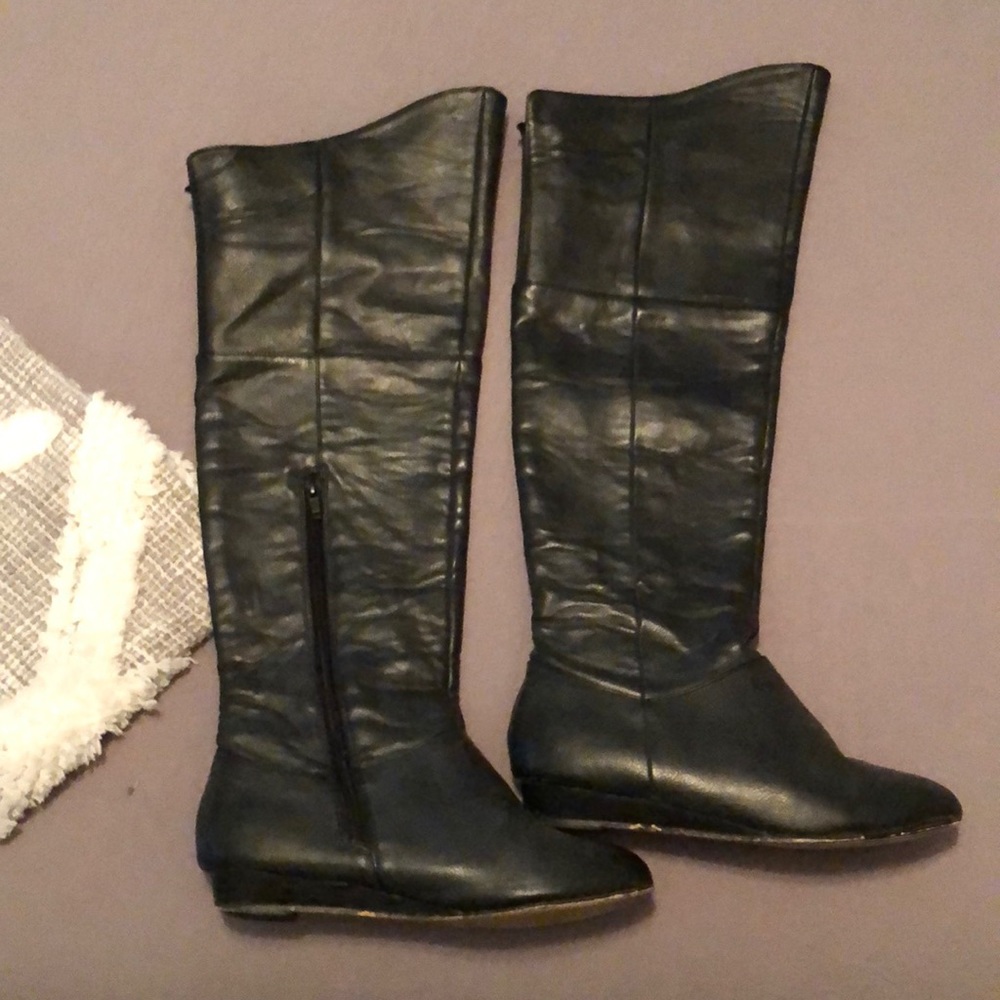 Knee high black leather boots.